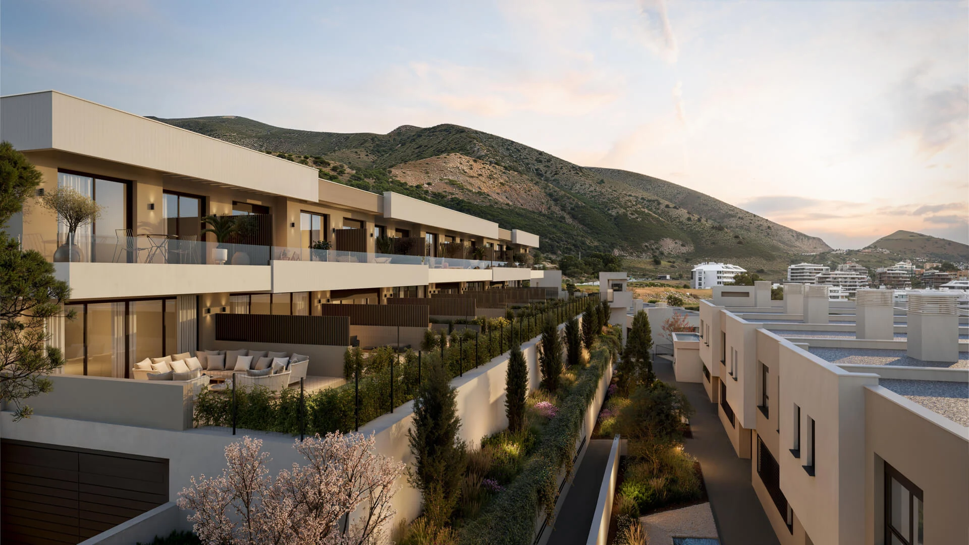 Kala Residences — townhouses bij zonsondergang tegen de bergen